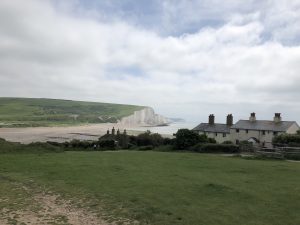 The Coastguard Cottages at Cuckmere Haven, with views of the white cliffs of the Severn Sisters which stretch between the mouth of the Cuckmere River and Eastbourne