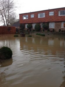 Flooded residential street in Alfriston, East Sussex, due to heavy rain fall inundating the Cuckmere River.